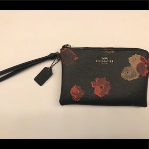 Black floral Coach corner zip wristlet